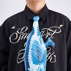Unique novelty tie featuring a blue X-ray skeleton design of a chameleon, an edgy and artistic fashion accessory for standout looks.