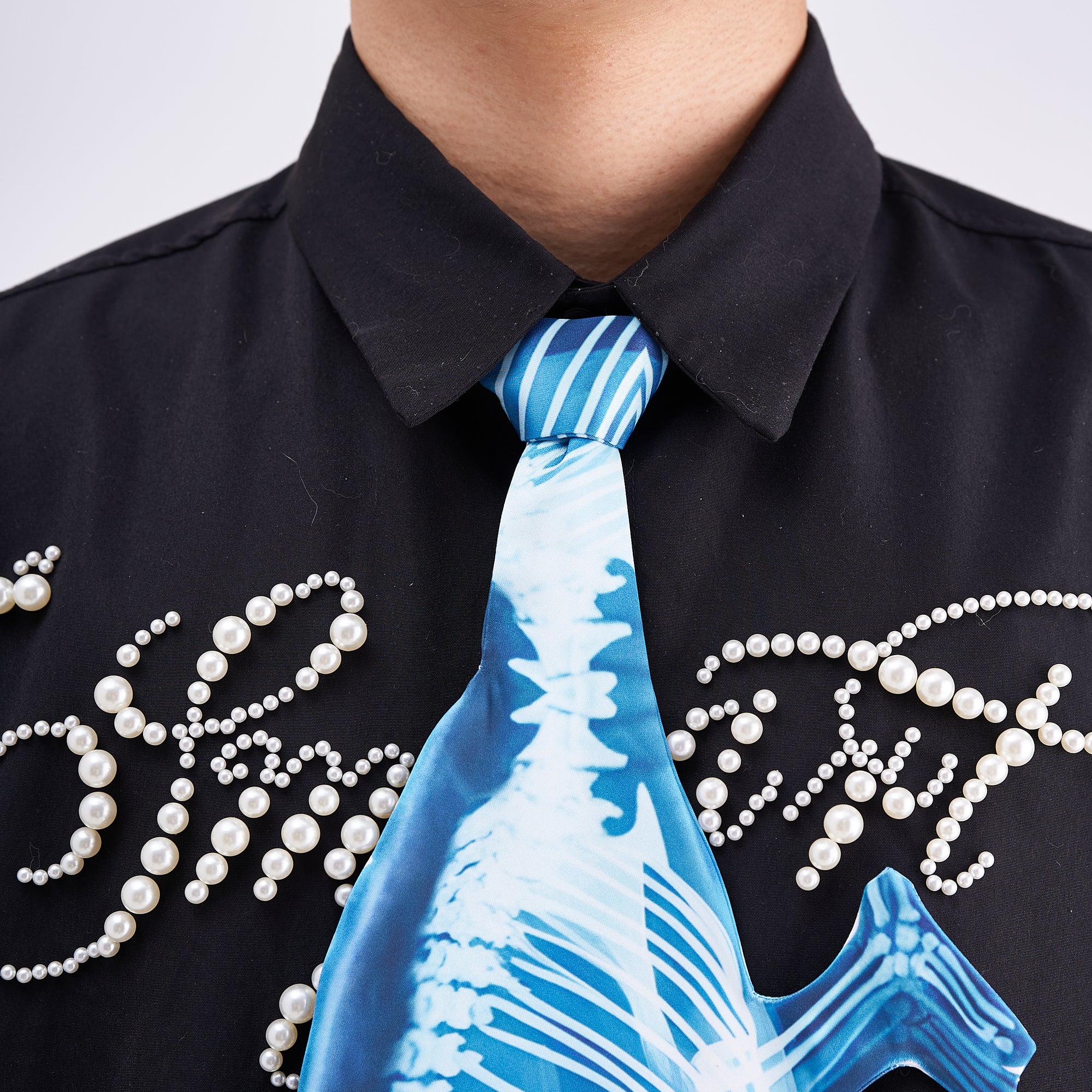Unique novelty tie featuring a blue X-ray skeleton design of a chameleon, an edgy and artistic fashion accessory for standout looks.