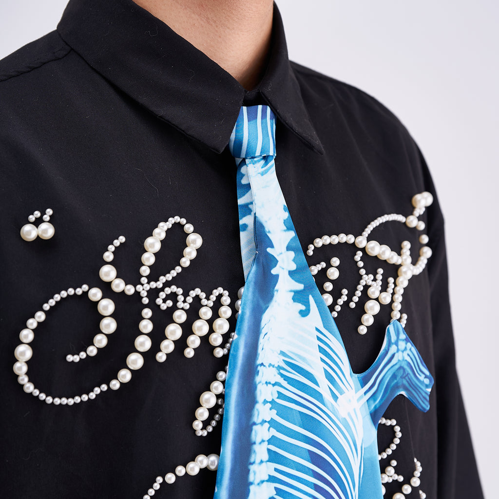 Unique novelty tie featuring a blue X-ray skeleton design of a chameleon, an edgy and artistic fashion accessory for standout looks.