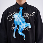 Unique novelty tie featuring a blue X-ray skeleton design of a monkey, a bold and edgy fashion accessory for creative outfits.