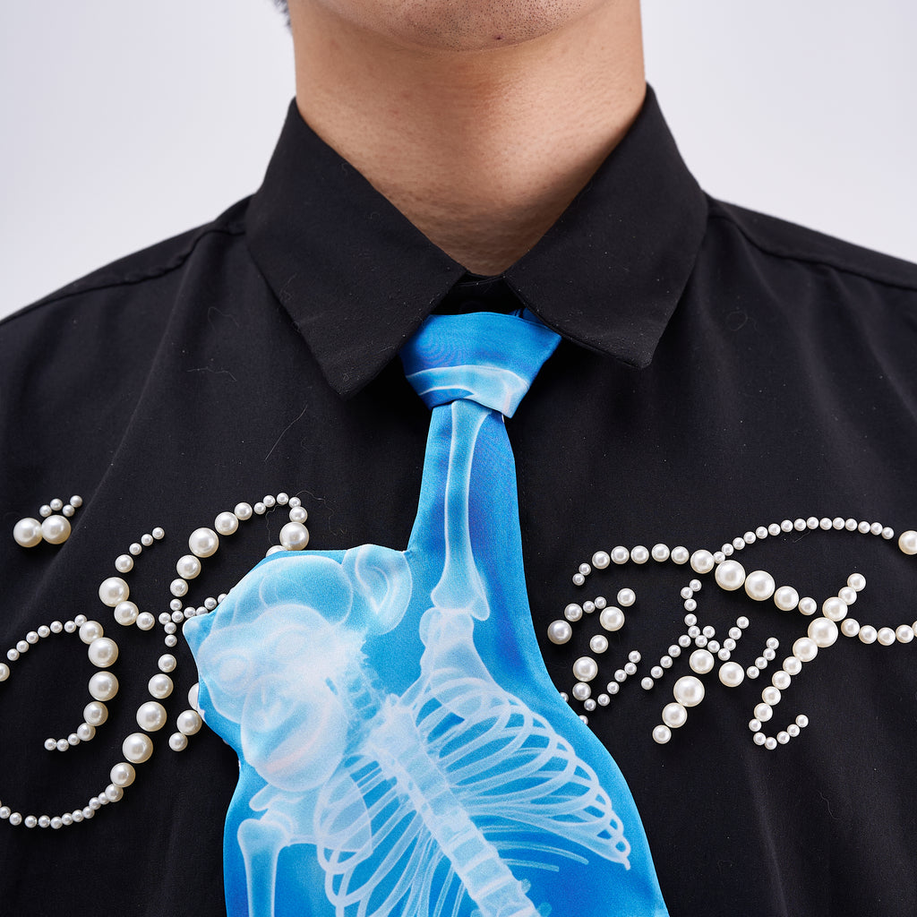 Unique novelty tie featuring a blue X-ray skeleton design of a monkey, a bold and edgy fashion accessory for creative outfits.
