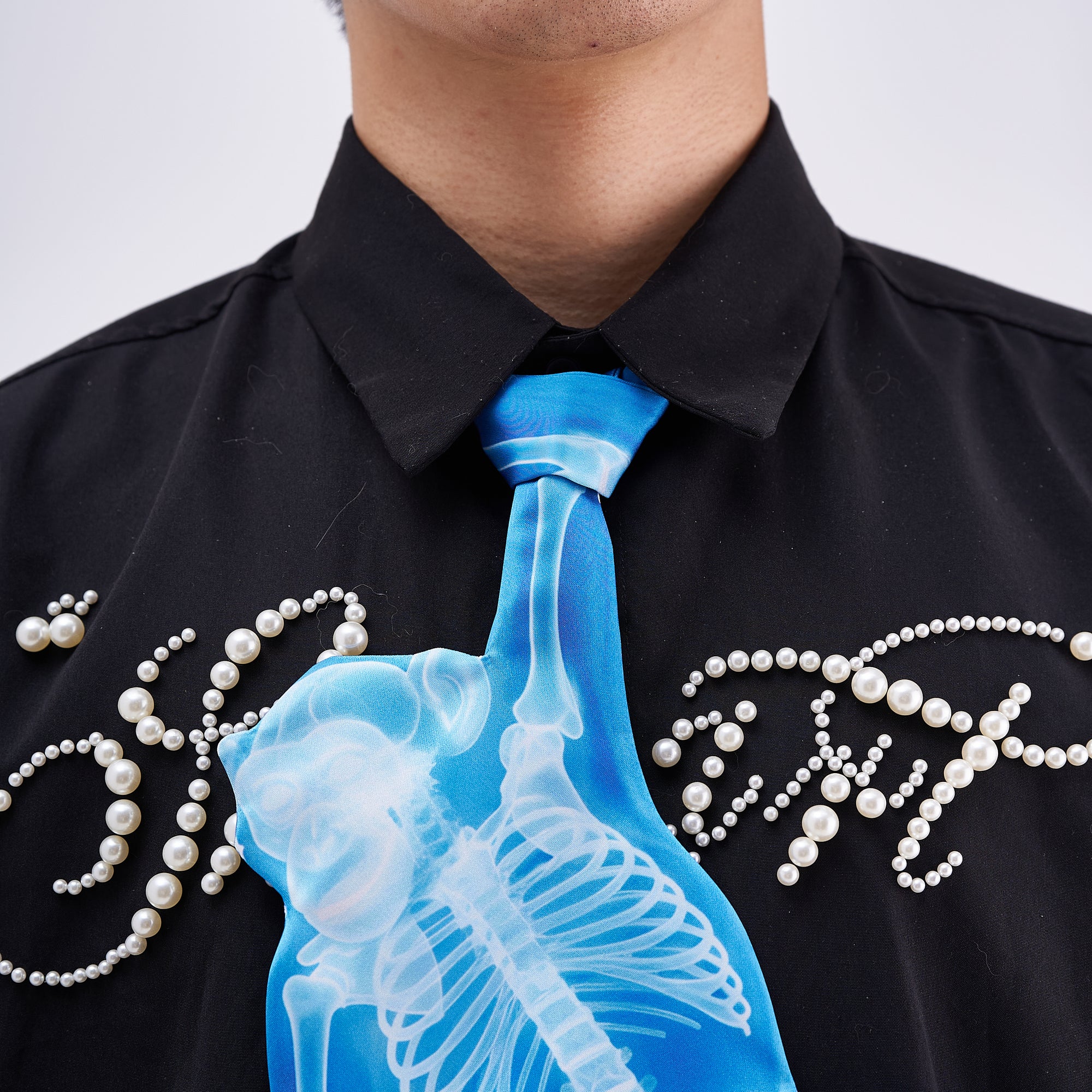 Unique novelty tie featuring a blue X-ray skeleton design of a monkey, a bold and edgy fashion accessory for creative outfits.