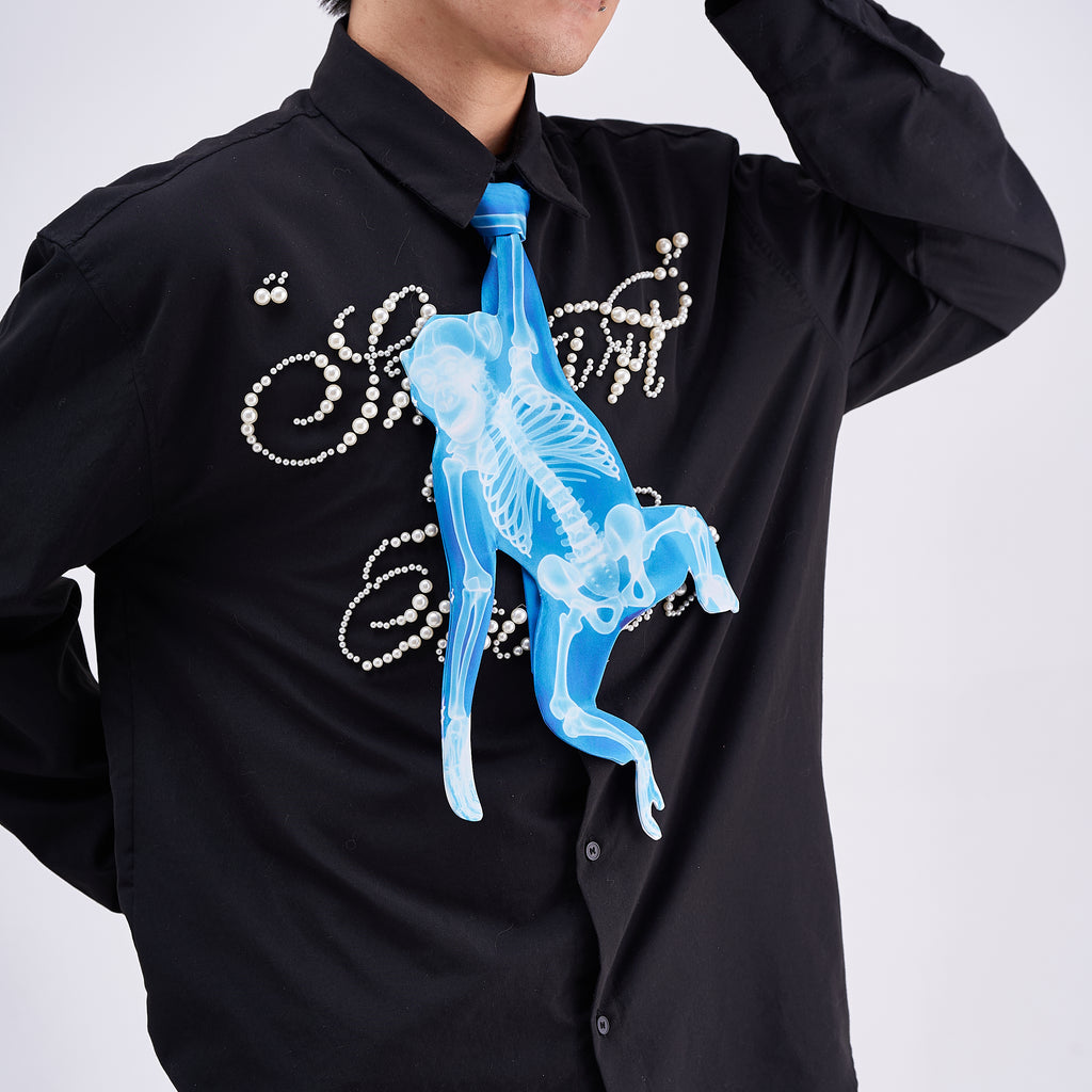 Unique novelty tie featuring a blue X-ray skeleton design of a monkey, a bold and edgy fashion accessory for creative outfits.