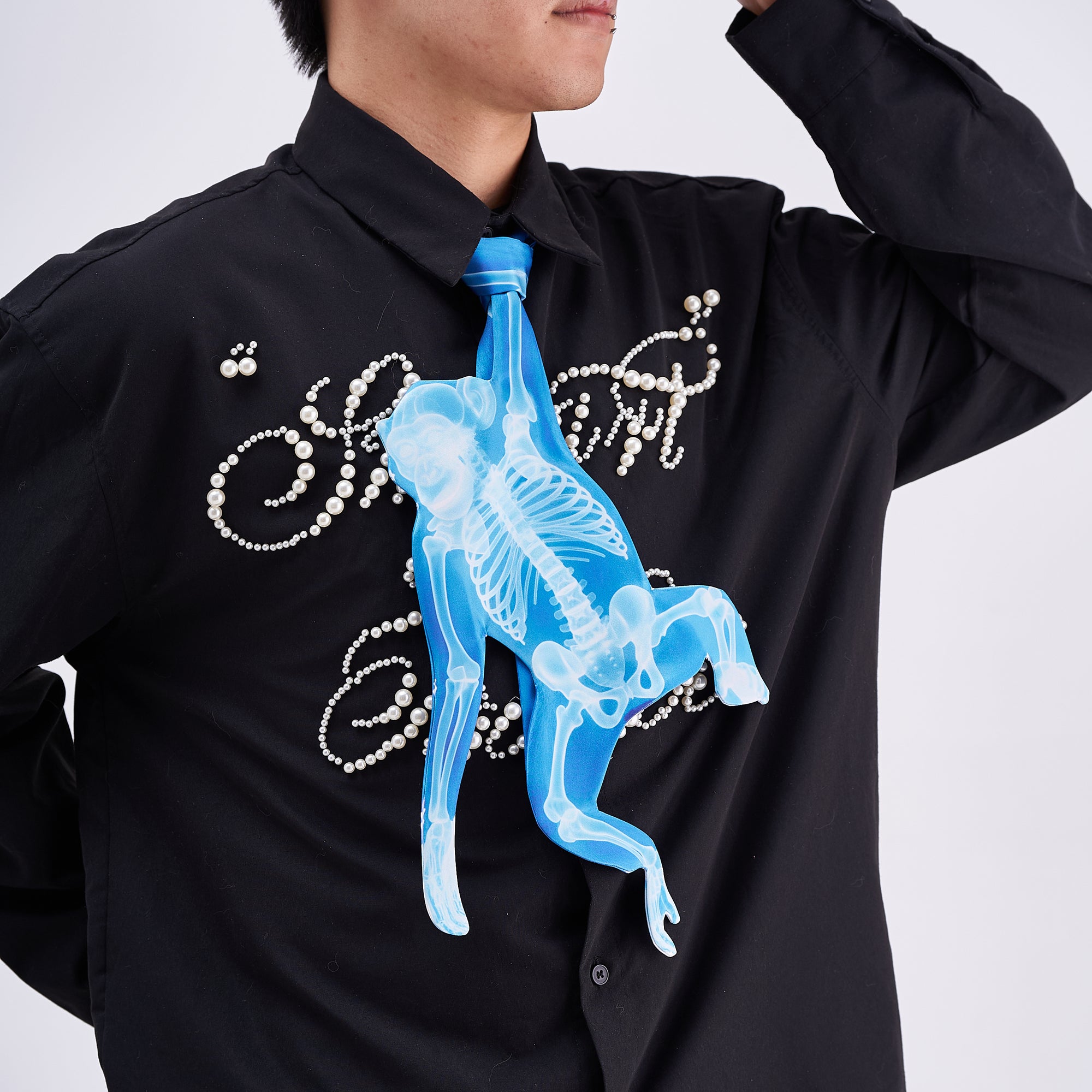 Unique novelty tie featuring a blue X-ray skeleton design of a monkey, a bold and edgy fashion accessory for creative outfits.