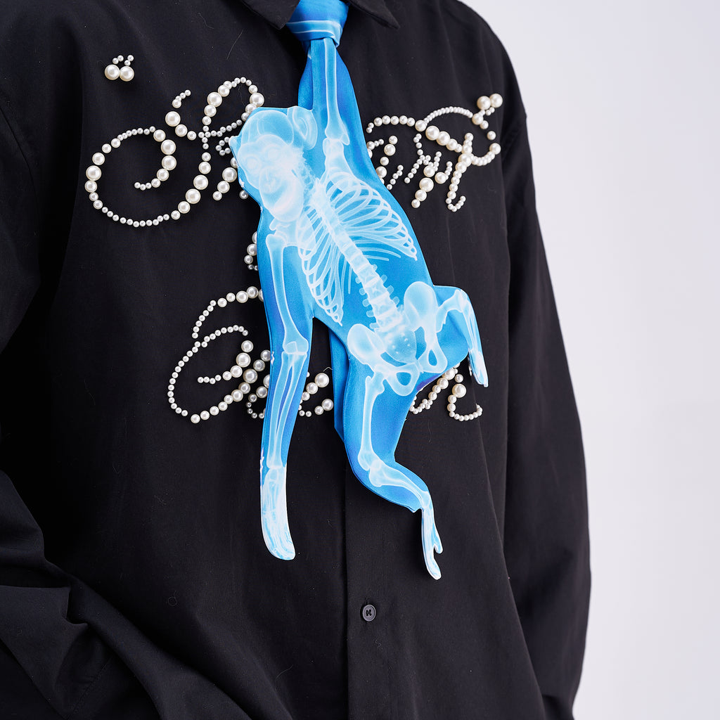 Unique novelty tie featuring a blue X-ray skeleton design of a monkey, a bold and edgy fashion accessory for creative outfits.
