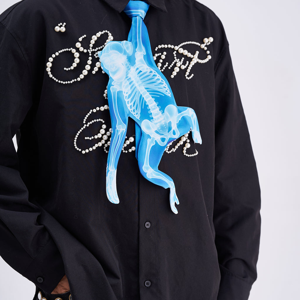 Unique novelty tie featuring a blue X-ray skeleton design of a monkey, a bold and edgy fashion accessory for creative outfits.