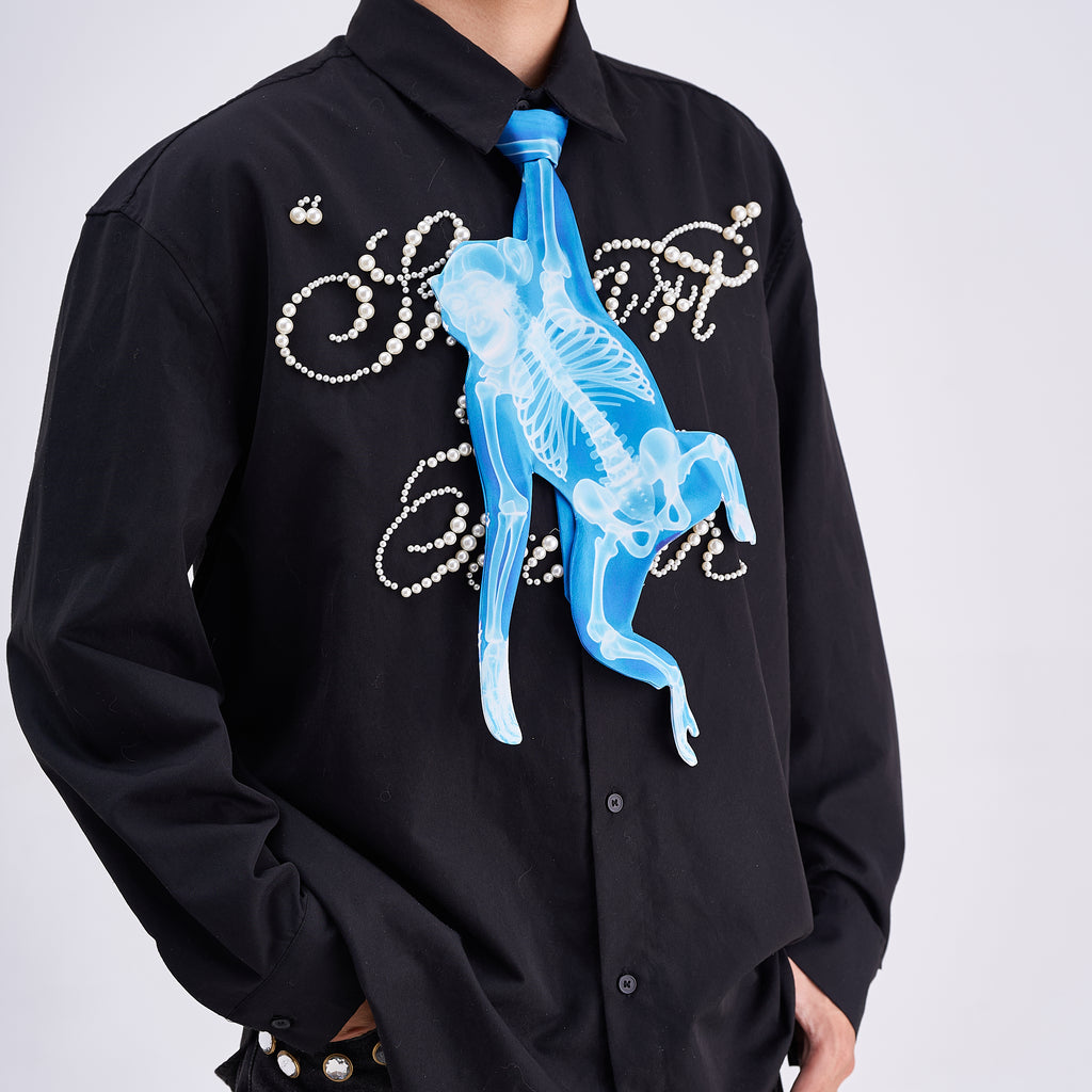 Unique novelty tie featuring a blue X-ray skeleton design of a monkey, a bold and edgy fashion accessory for creative outfits.