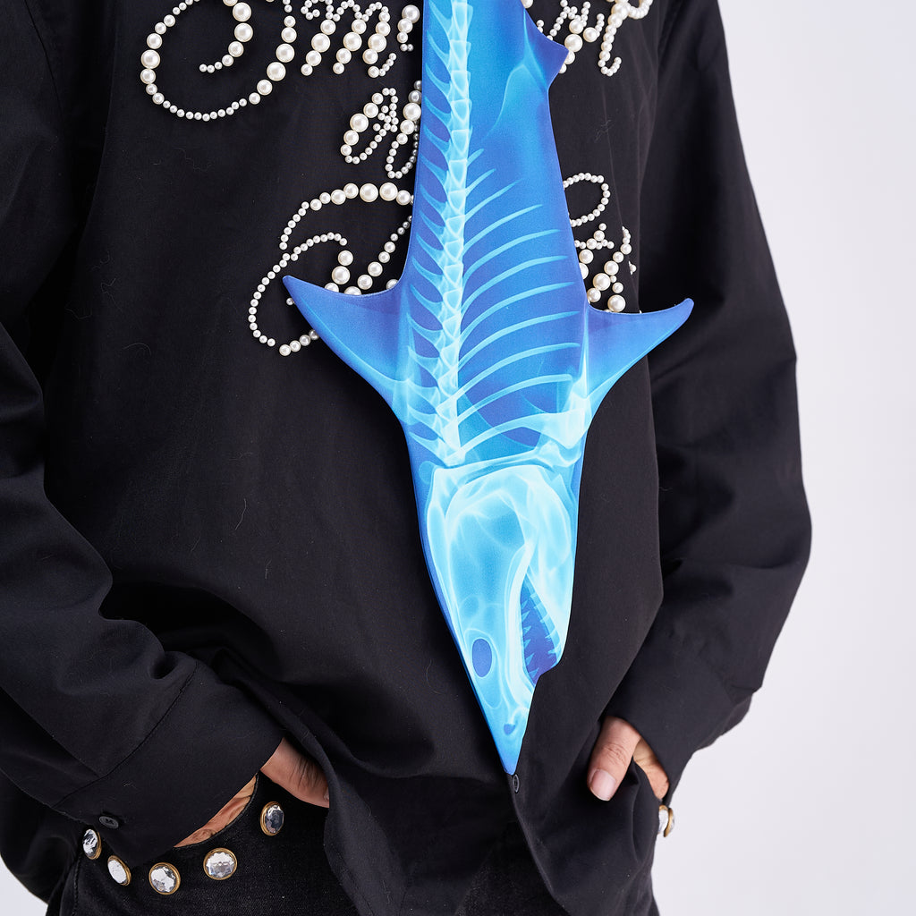 Unique novelty necktie featuring a blue X-ray skeleton design of a shark, a bold and edgy fashion accessory.