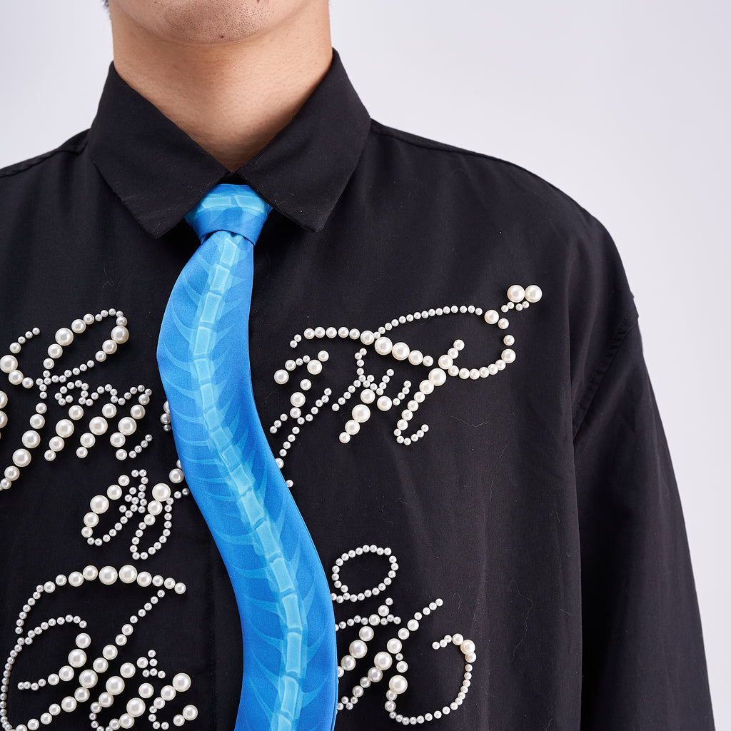 Unique novelty necktie featuring a blue X-ray spine skeleton design, a bold and edgy fashion accessory.