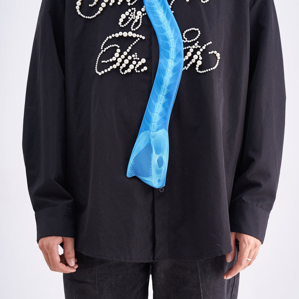 Unique novelty necktie featuring a blue X-ray spine skeleton design, a bold and edgy fashion accessory.