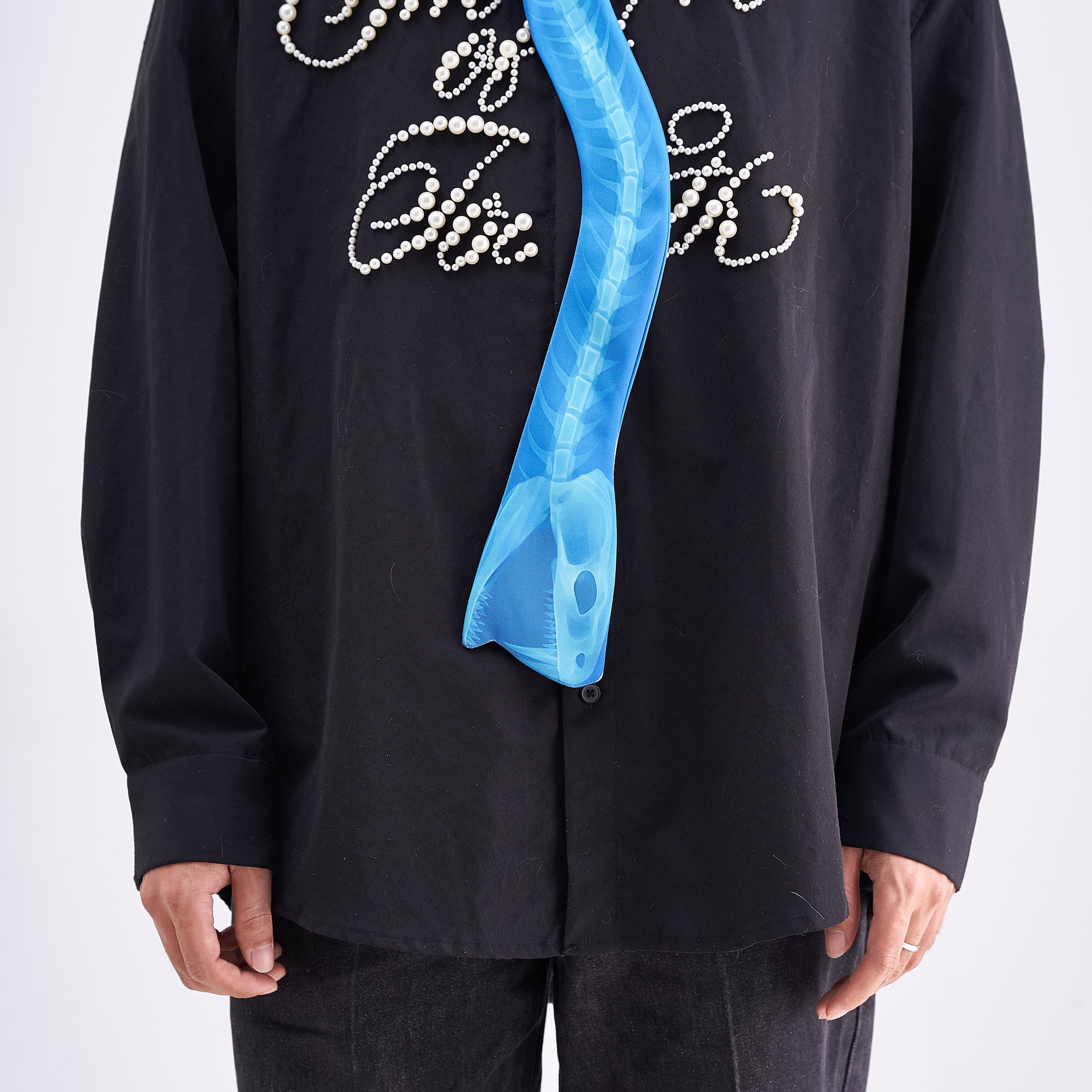 Unique novelty necktie featuring a blue X-ray spine skeleton design, a bold and edgy fashion accessory.