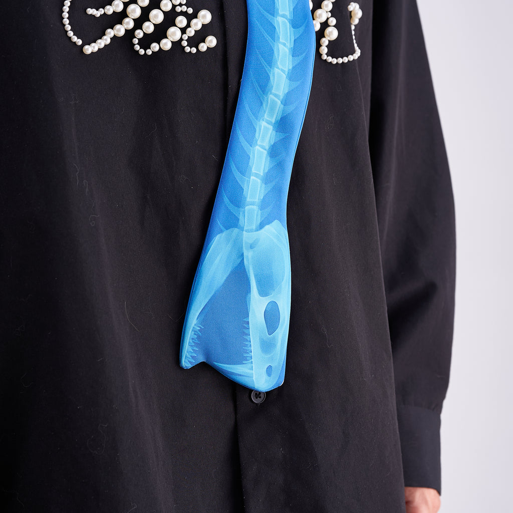 Unique novelty necktie featuring a blue X-ray spine skeleton design, a bold and edgy fashion accessory.