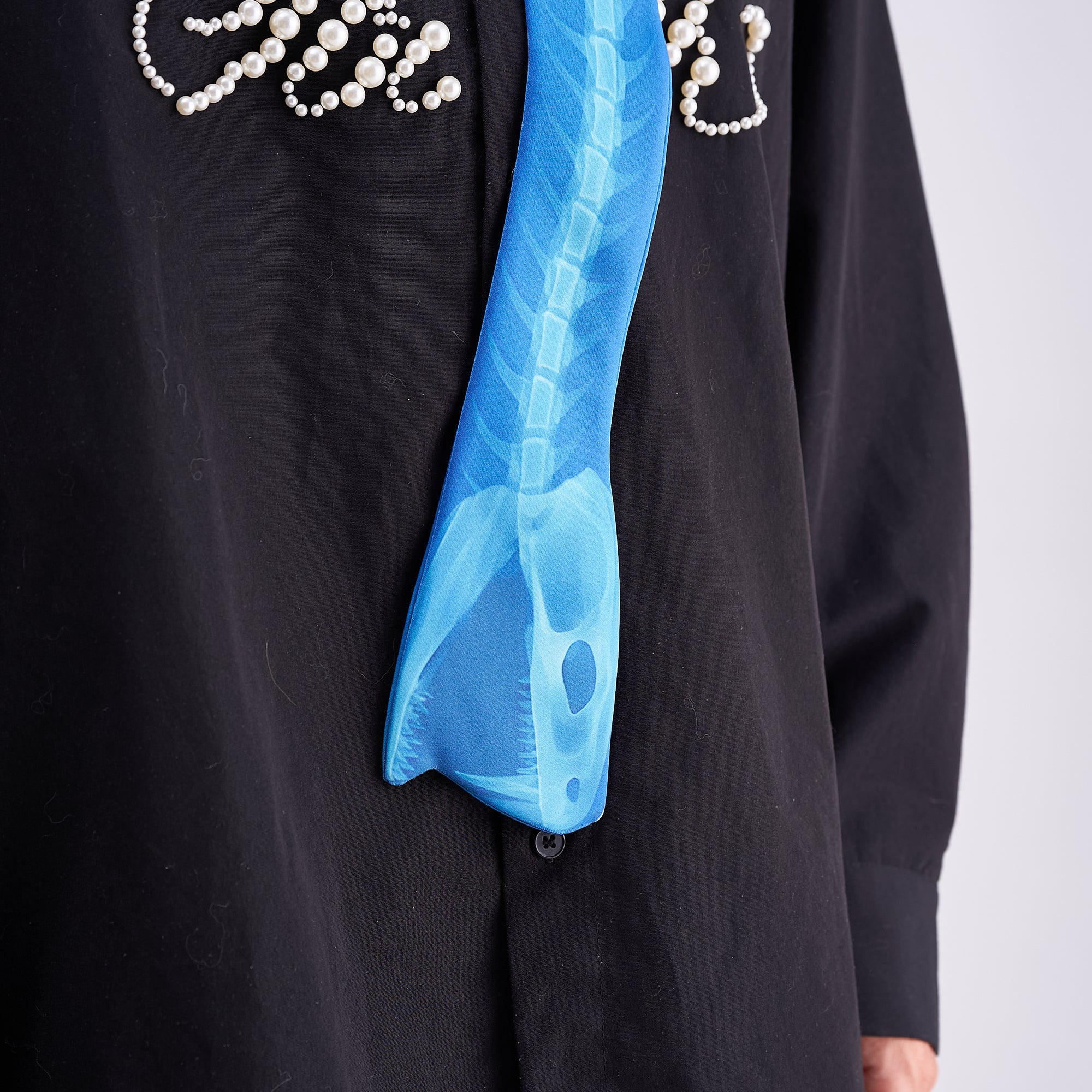 Unique novelty necktie featuring a blue X-ray spine skeleton design, a bold and edgy fashion accessory.