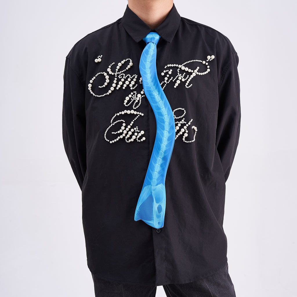 Unique novelty necktie featuring a blue X-ray spine skeleton design, a bold and edgy fashion accessory.