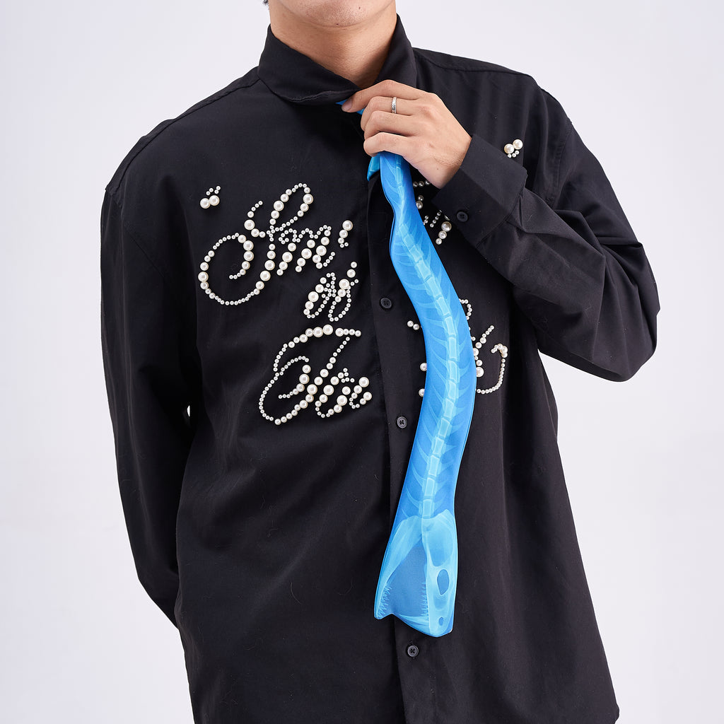 Unique novelty necktie featuring a blue X-ray spine skeleton design, a bold and edgy fashion accessory.