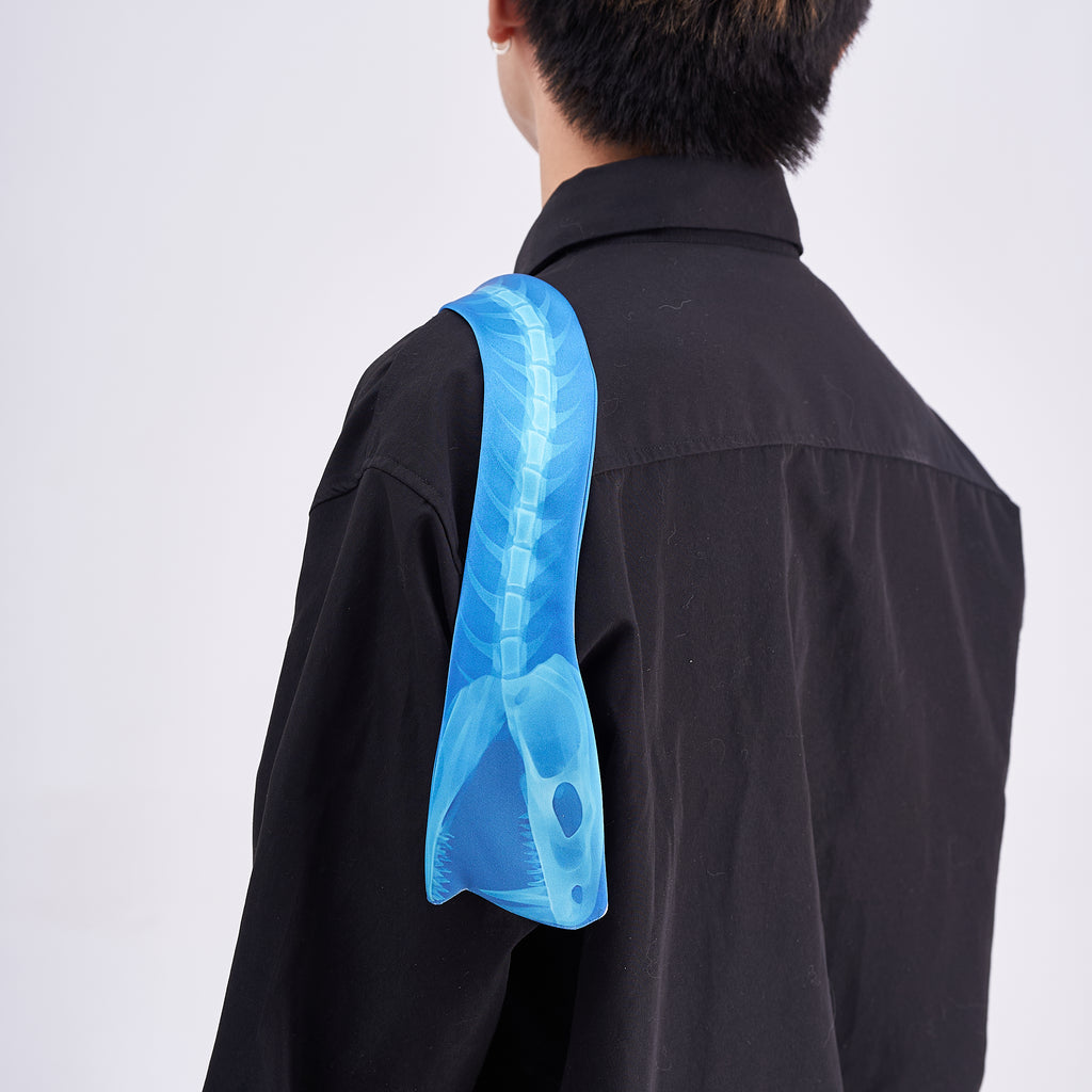 Unique novelty necktie featuring a blue X-ray spine skeleton design, a bold and edgy fashion accessory.
