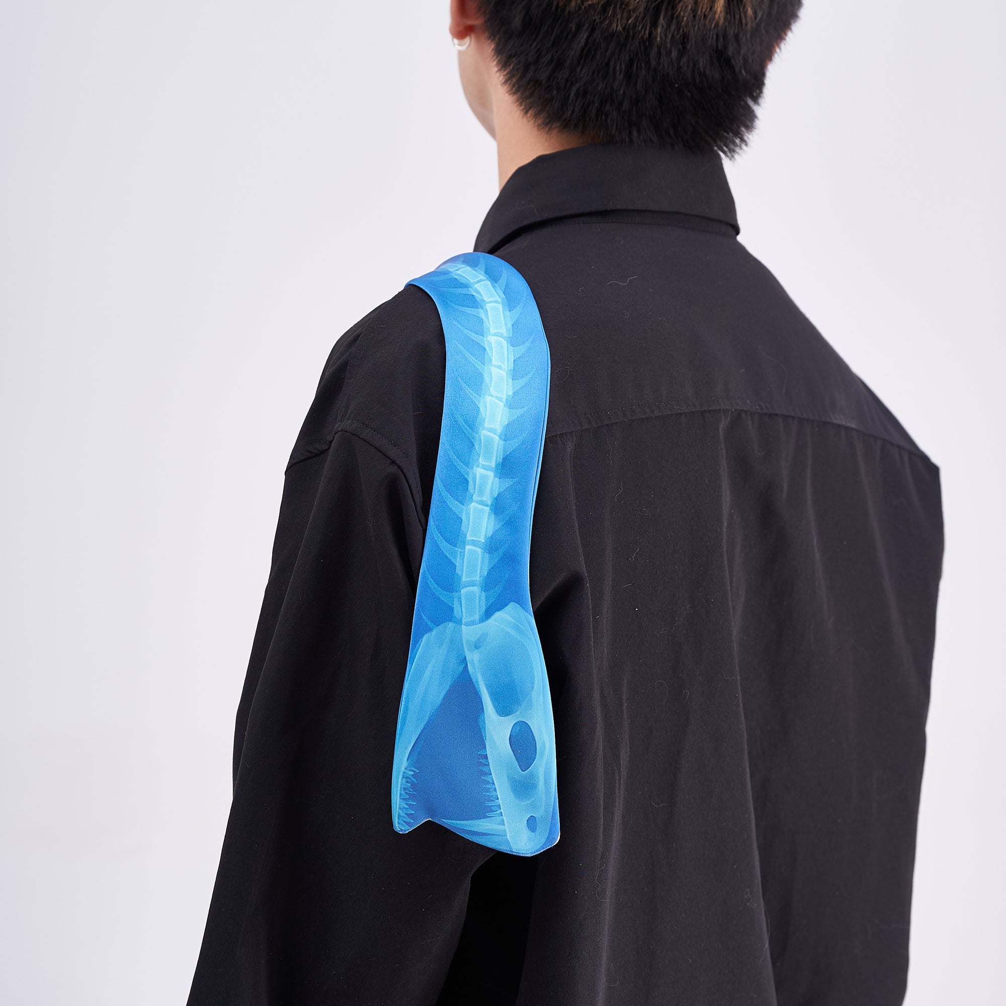 Unique novelty necktie featuring a blue X-ray spine skeleton design, a bold and edgy fashion accessory.